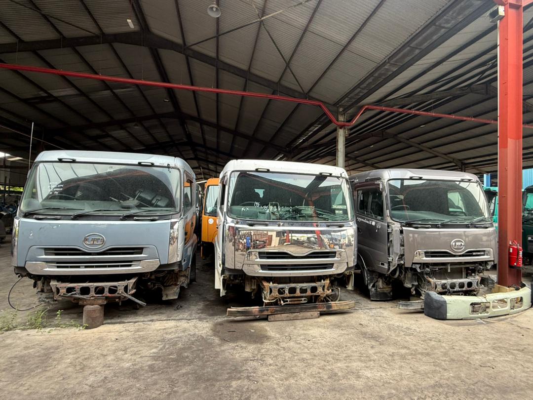 Row of Nissan Diesel / UD cabin assemblies staged in the M.R. & Sons warehouse.